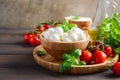 Italian food ingredients Ã¢â¬â mozzarella, tomatoes, basil and olive oil on rustic wooden table. Royalty Free Stock Photo